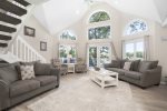 Living room with soaring ceilings and large windows overlooking Silver Lake